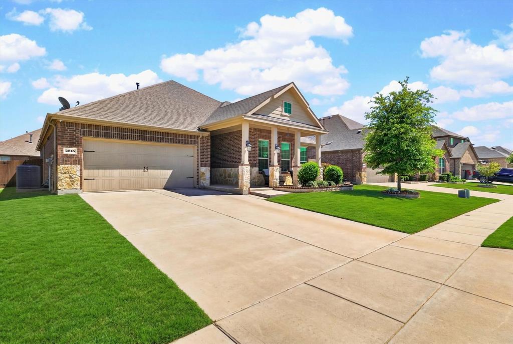 2816 Permian Road Aubrey, TX 76227 - Photo 27 of 36 Craftsman house featuring a garage, a front lawn, brick siding, concrete driveway, and roof with shingles