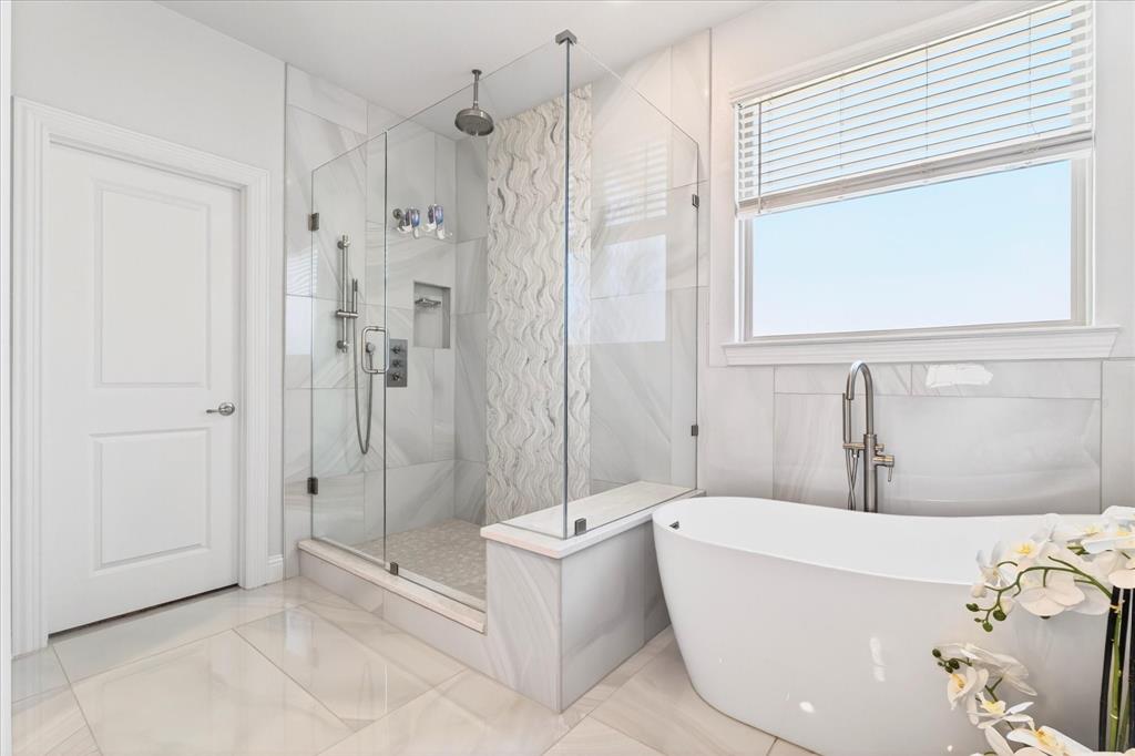 2816 Permian Road Aubrey, TX 76227 - Photo 7 of 36 Bathroom featuring a marble finish shower and a freestanding bath
