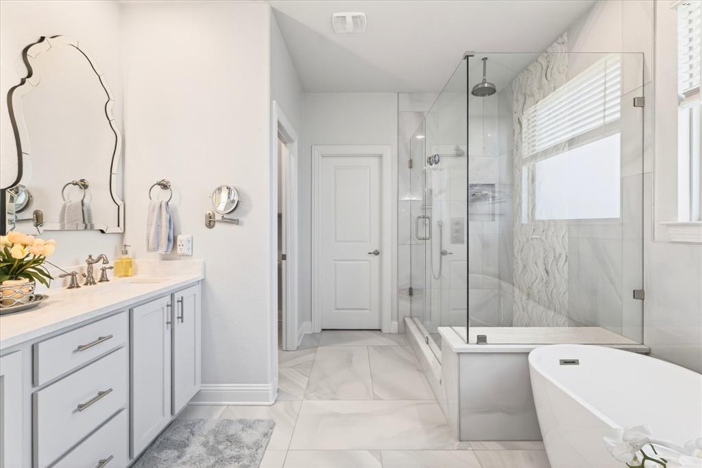 2816 Permian Road Aubrey, TX 76227 - Photo 8 of 36 Bathroom featuring vanity, a marble finish shower, a freestanding tub, and light marble finish floors