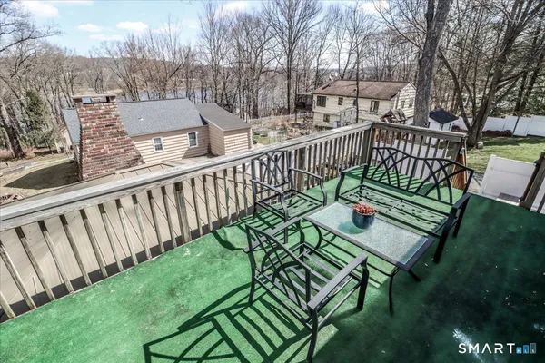 a view of a wooden deck with furniture
