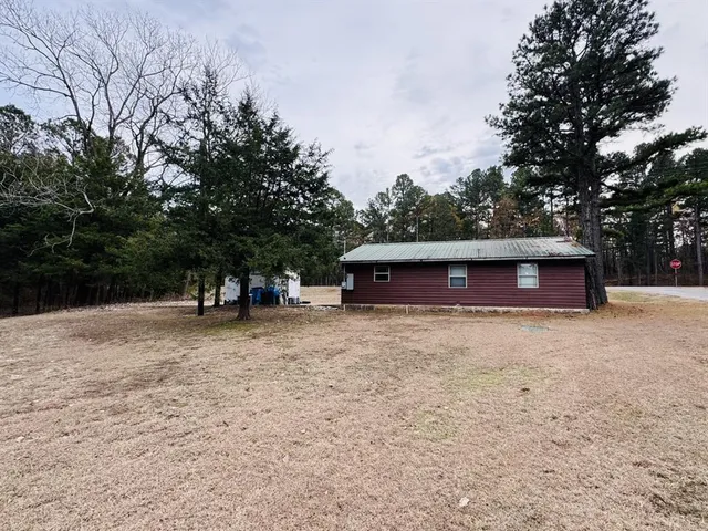 a view of a house with a yard and tree s