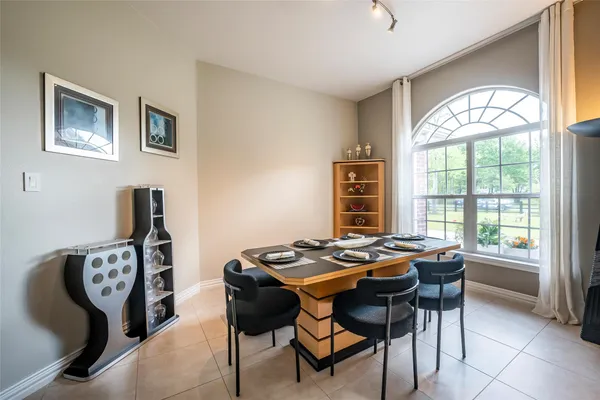 a large kitchen with a table and chairs