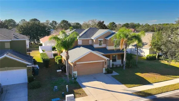 an aerial view of a house with a yard