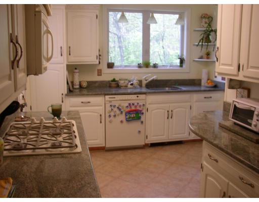 10 Common Street Norwell, MA 02061 - Photo 17 of 27 a kitchen with stainless steel appliances granite countertop a stove a sink and a microwave