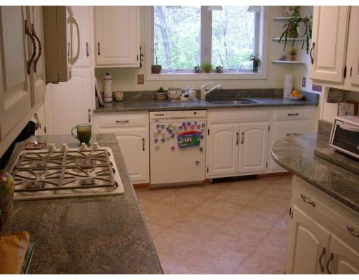 10 Common Street Norwell, MA 02061 - Photo 18 of 27 a kitchen with granite countertop a stove sink and cabinets