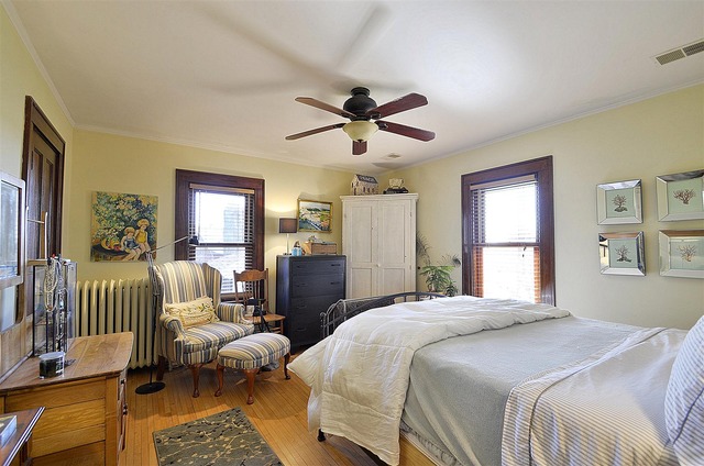 43W424 Burlington Road Elgin, IL 60124 - Photo 14 of 25 a bedroom with a bed and a chandelier