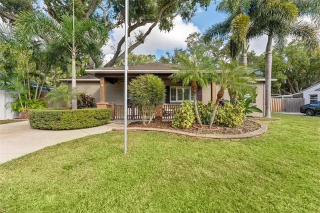 a view of a house with backyard and sitting area