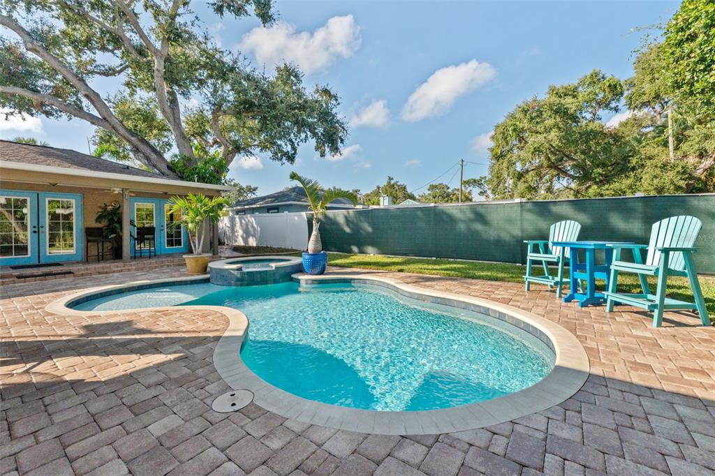 1441 Santa Anna Drive Dunedin, FL 34698 - Photo 2 of 34 a view of a swimming pool with a patio