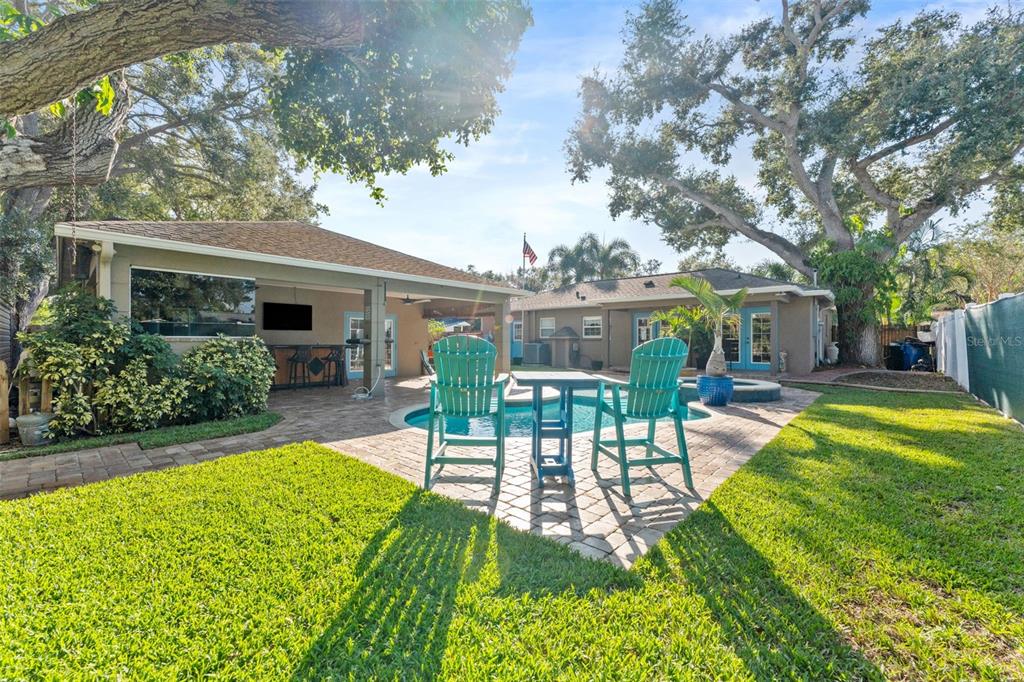 1441 Santa Anna Drive Dunedin, FL 34698 - Photo 22 of 34 a view of a house with backyard patio and swimming pool