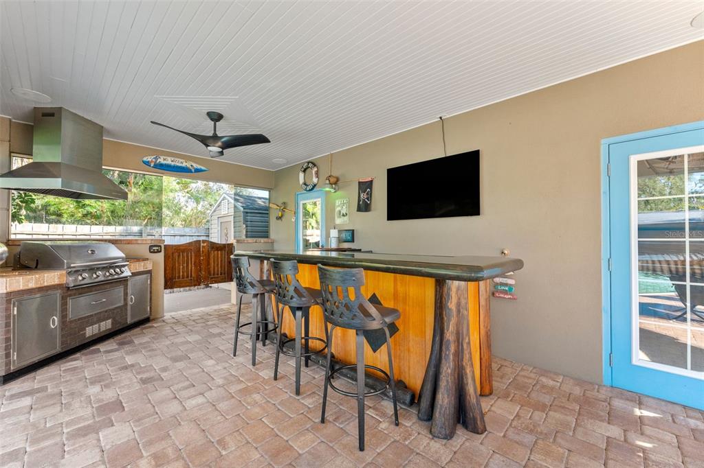 1441 Santa Anna Drive Dunedin, FL 34698 - Photo 24 of 34 a dining room with furniture a window and a flat screen tv