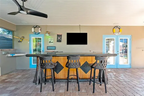 a view of a dining room with furniture and a flat screen tv