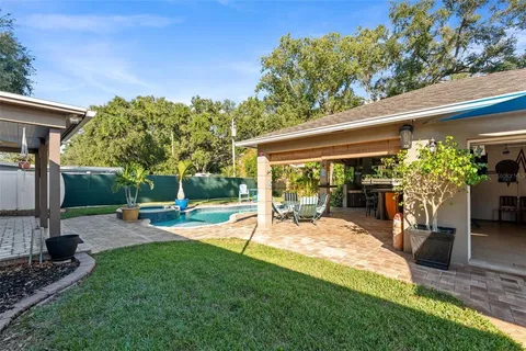 a view of a backyard with plants and a patio