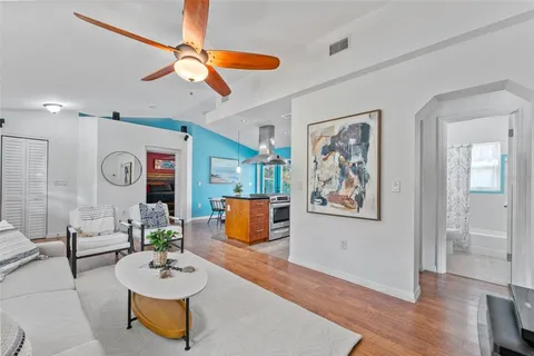 a living room with furniture and a wooden floor