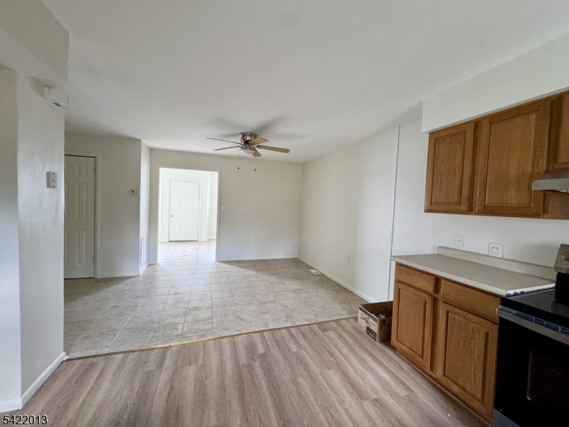 a view of a kitchen with wooden floor and electronic appliances