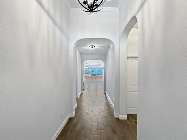 a view of a hallway with wooden floor and closet