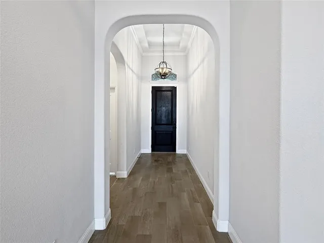a view of a hallway view with a chandelier