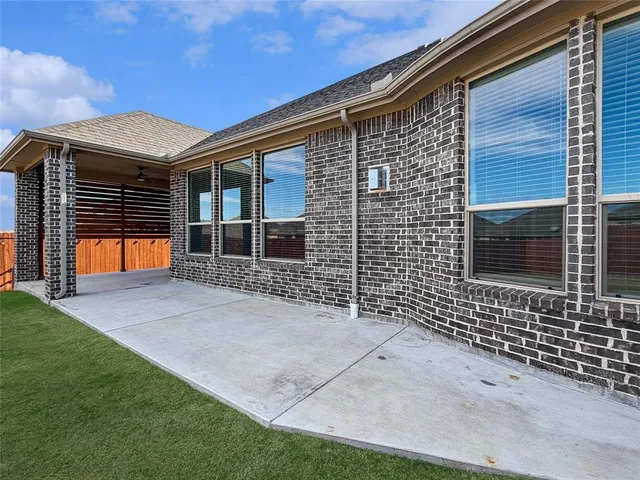 a view of a big house with a big yard and large trees