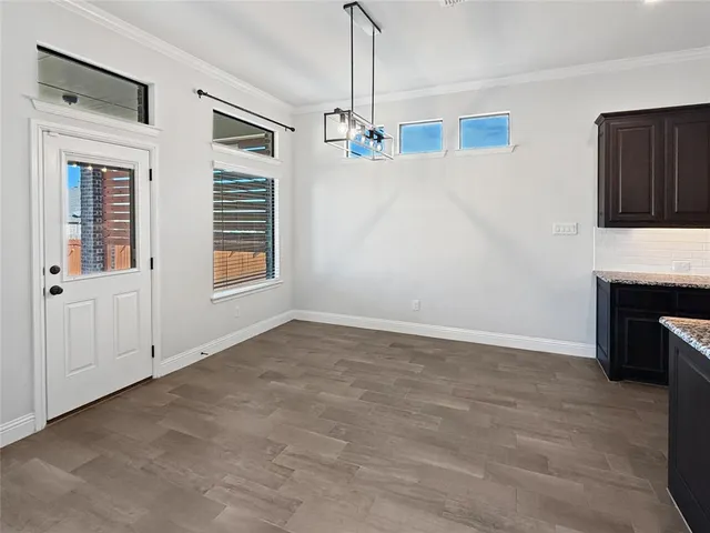 a view of empty room with fireplace and window