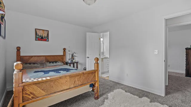 a bedroom with a bed and a mirror