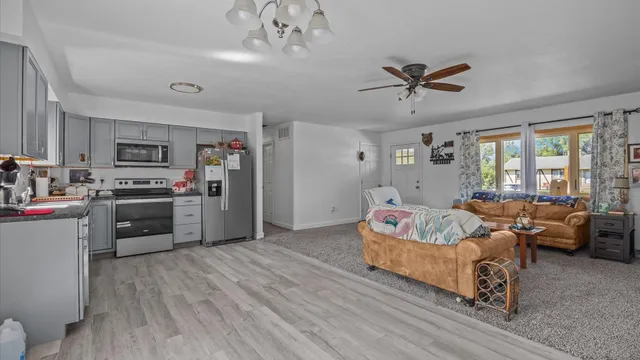 a living room with furniture and kitchen view