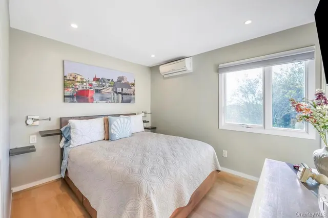 a bedroom with a bed and a painting on the wall