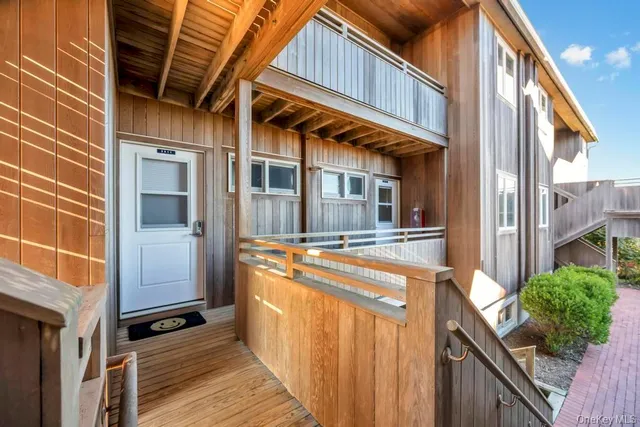 a view of a house with a door and wooden walls