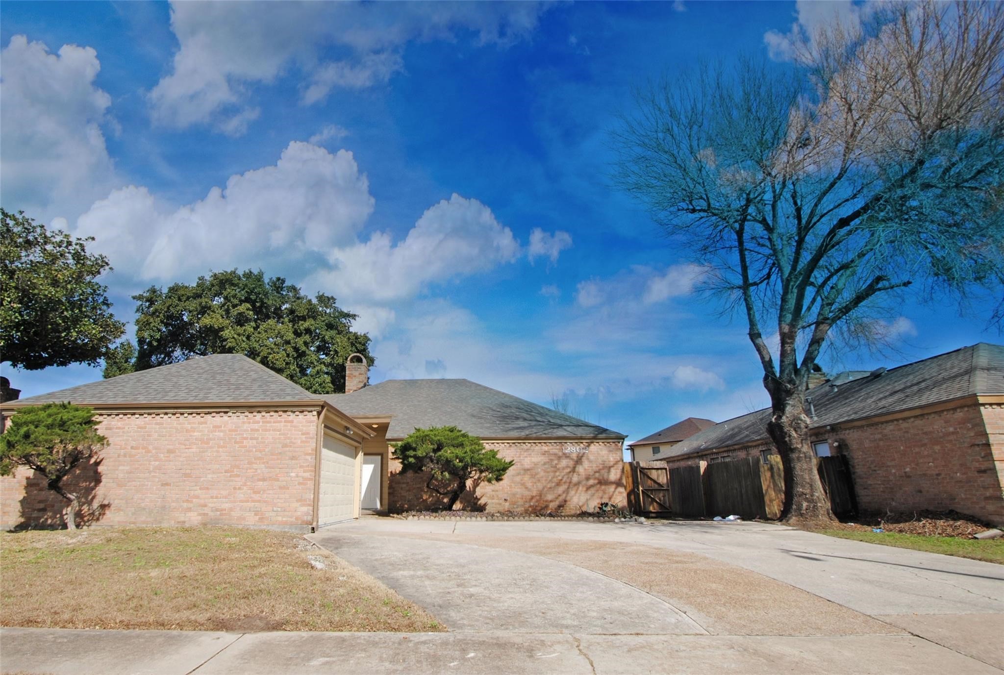 12802 Newbrook Drive Houston, TX 77072 - Photo 1 of 17 a view of a house with a yard