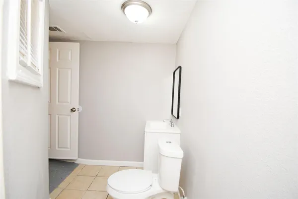 a view of a room with wooden floor and window
