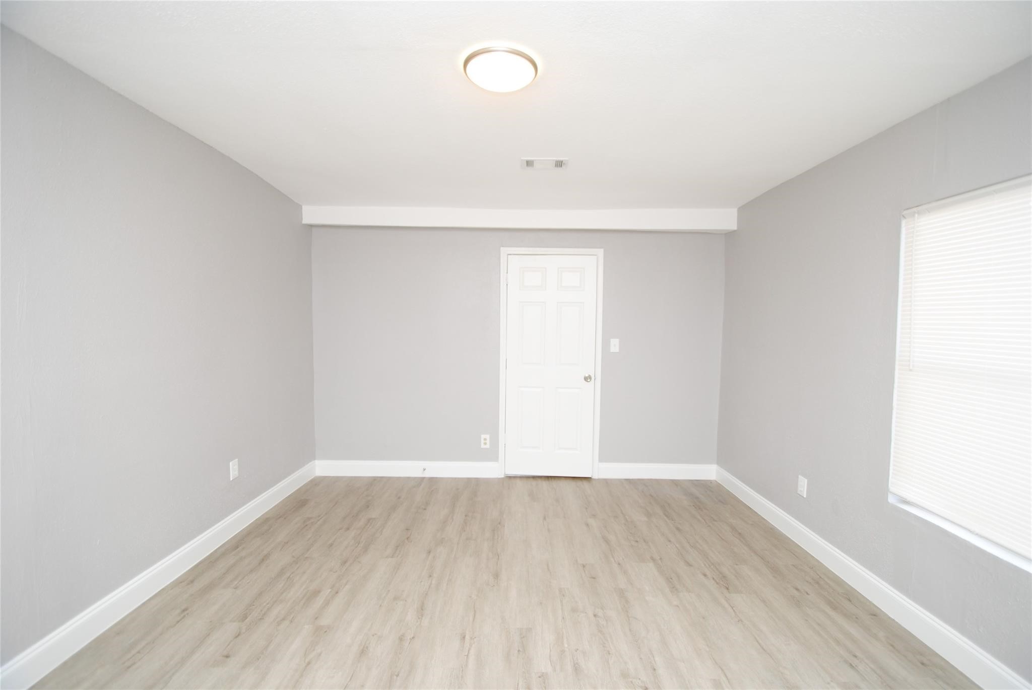 12802 Newbrook Drive Houston, TX 77072 - Photo 15 of 17 a view of a room with wooden floor and window