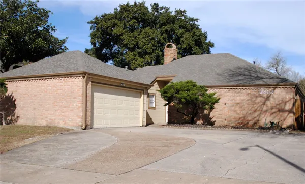 a view of a house with a yard and garage