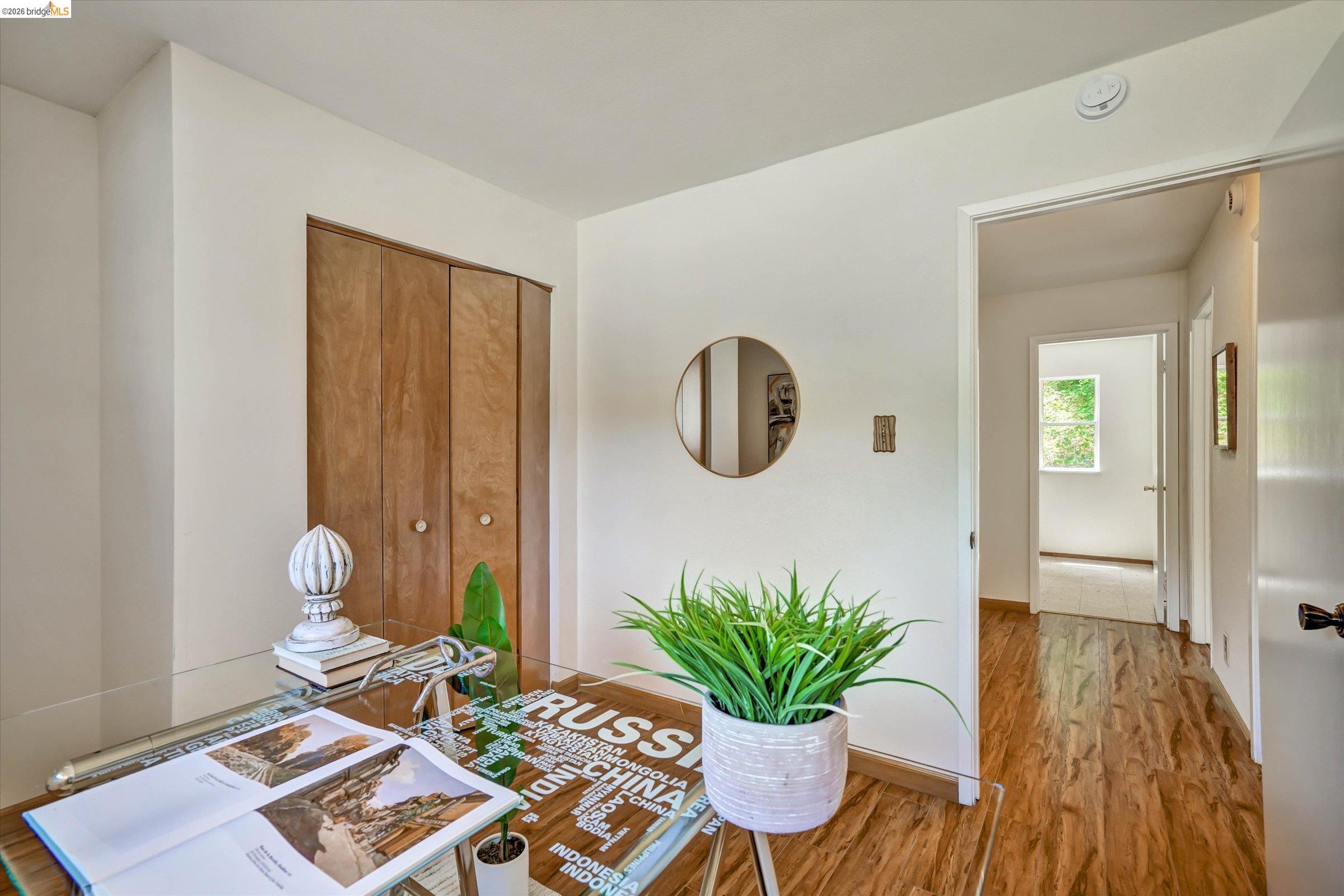 2826 Wright Avenue Pinole, CA 94564 - Photo 24 of 70 Room featuring wood-finish flooring, white painted walls, and bi-fold closet doors