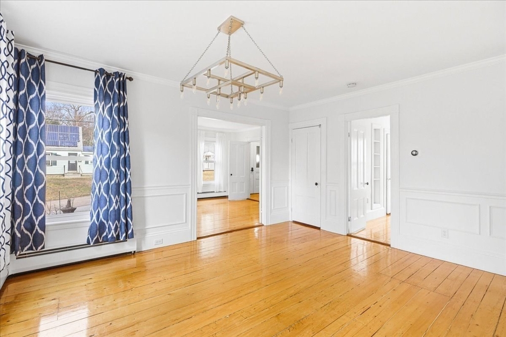 16 Howard Avenue Holbrook, MA 02343 - Photo 13 of 40 a view of an empty room with window and wooden floor