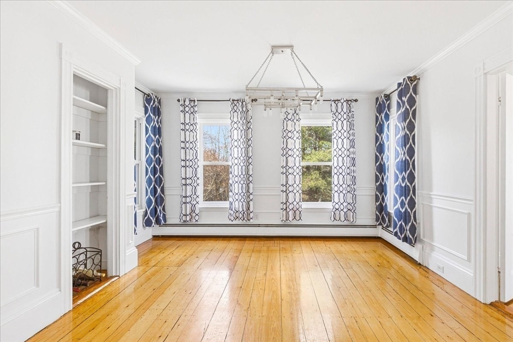 16 Howard Avenue Holbrook, MA 02343 - Photo 16 of 40 a view of a room with window wooden floor and table next to a window