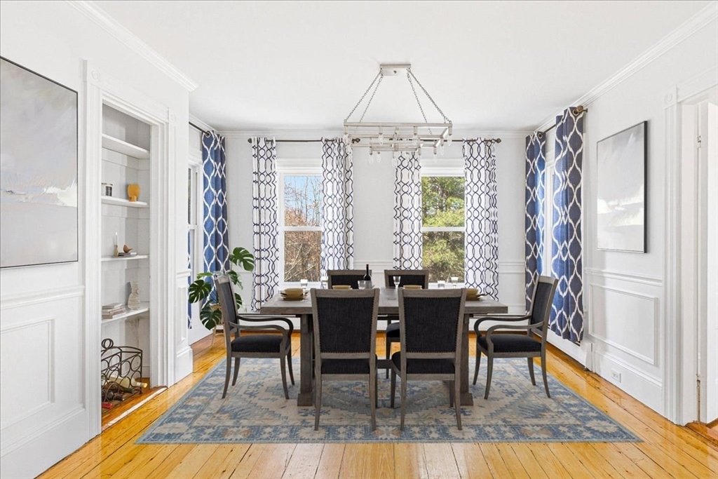 16 Howard Avenue Holbrook, MA 02343 - Photo 17 of 40 a dining room with wooden floor a chandelier a wooden table and chairs