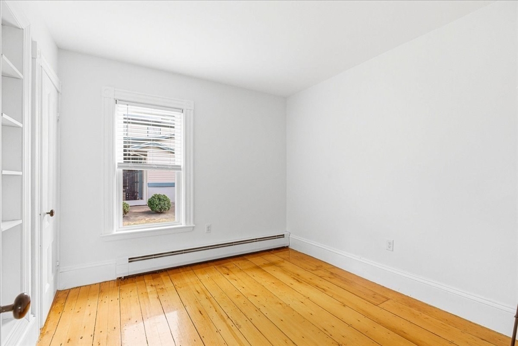 16 Howard Avenue Holbrook, MA 02343 - Photo 19 of 40 a view of an empty room with wooden floor and a window