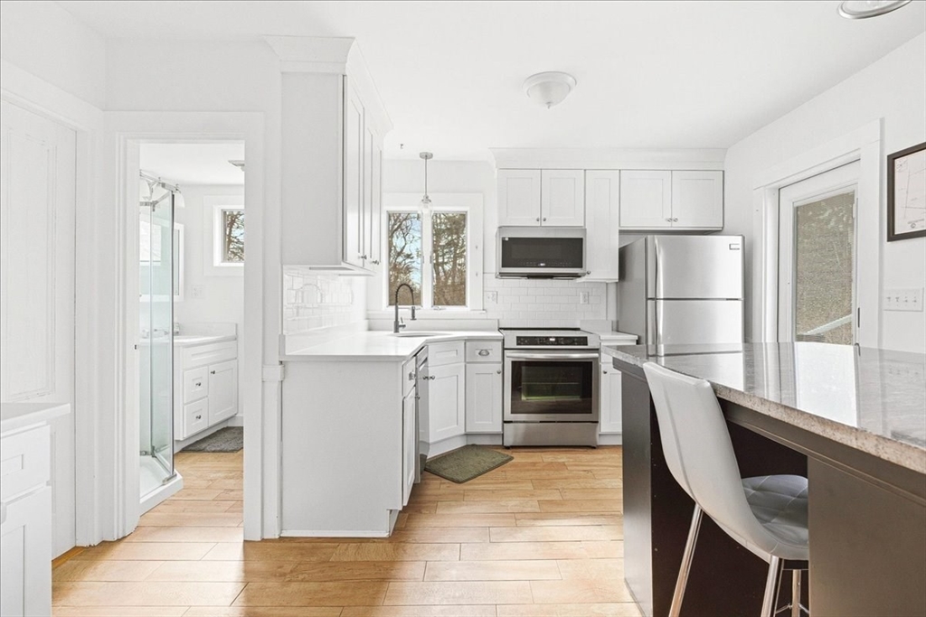 16 Howard Avenue Holbrook, MA 02343 - Photo 20 of 40 a kitchen with white cabinets and stainless steel appliances