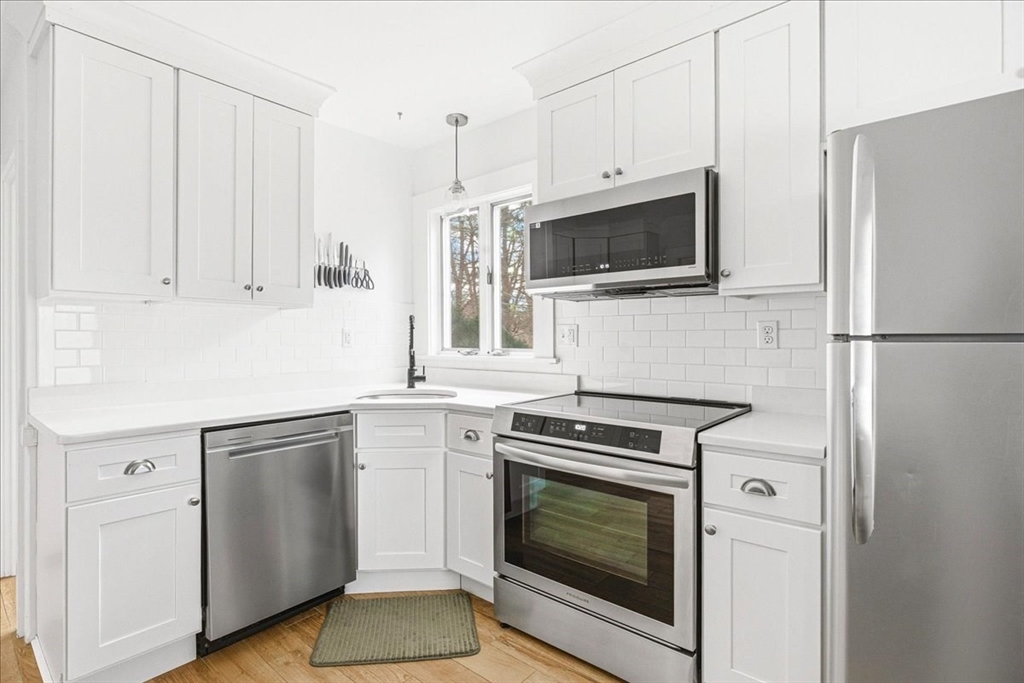 16 Howard Avenue Holbrook, MA 02343 - Photo 23 of 40 a kitchen with cabinets stainless steel appliances and wooden floor