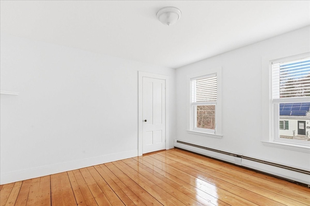 16 Howard Avenue Holbrook, MA 02343 - Photo 29 of 40 an empty room with wooden floor and windows