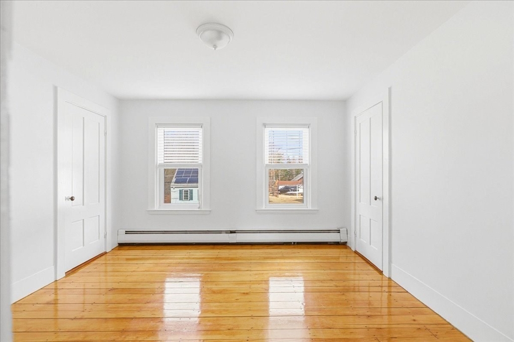 16 Howard Avenue Holbrook, MA 02343 - Photo 30 of 40 a view of an empty room with wooden floor and a window