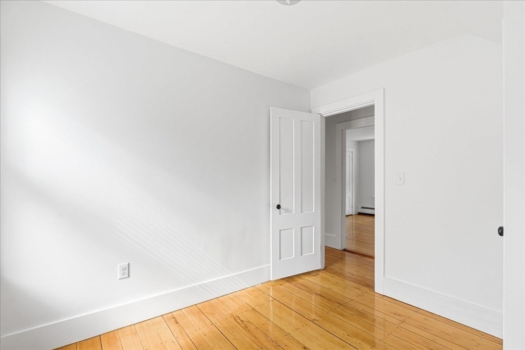 16 Howard Avenue Holbrook, MA 02343 - Photo 31 of 40 a view of an empty room with wooden floor