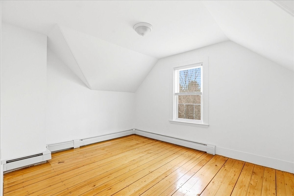 16 Howard Avenue Holbrook, MA 02343 - Photo 32 of 40 an empty room with wooden floor and windows