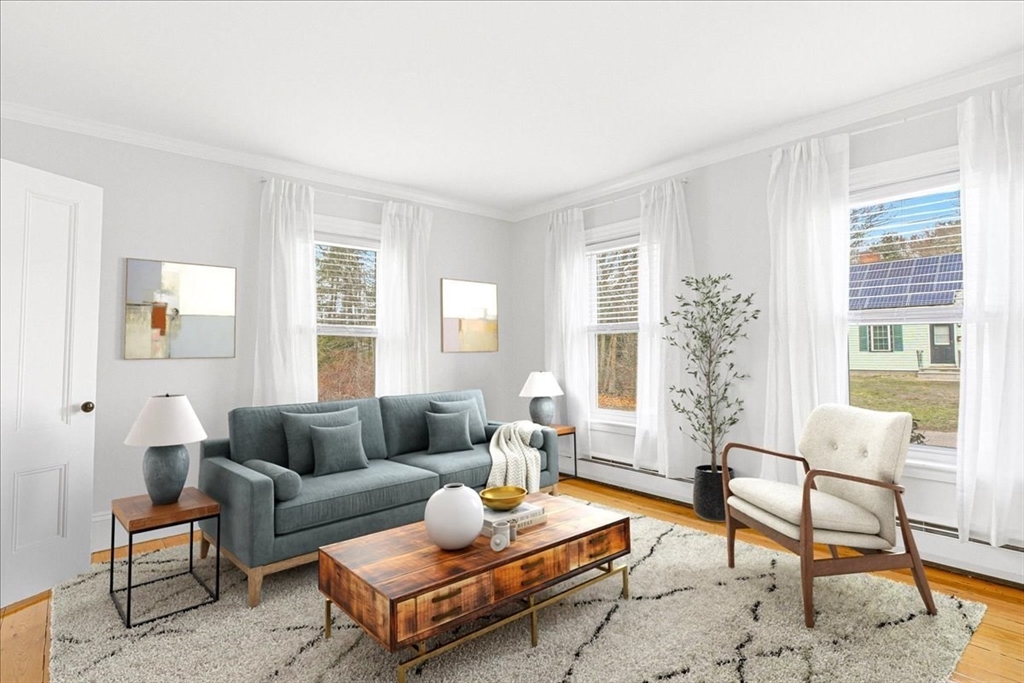 16 Howard Avenue Holbrook, MA 02343 - Photo 10 of 40 a living room with furniture and a potted plant next to a window