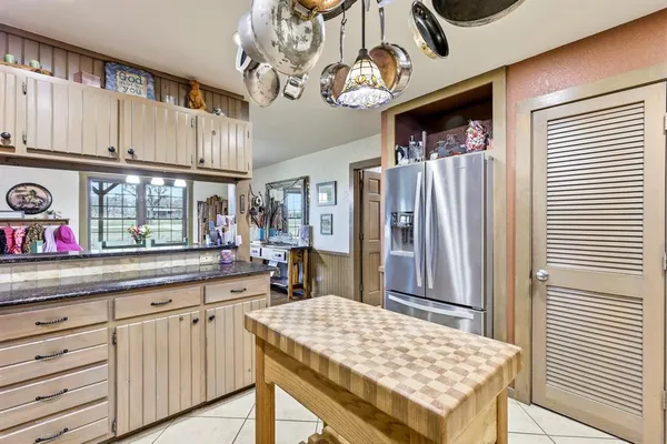 a kitchen with a table and chairs in it