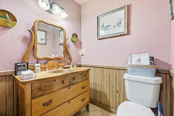 a bathroom with a sink mirror vanity and toilet