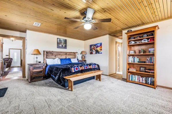 a bedroom with furniture and a book shelf