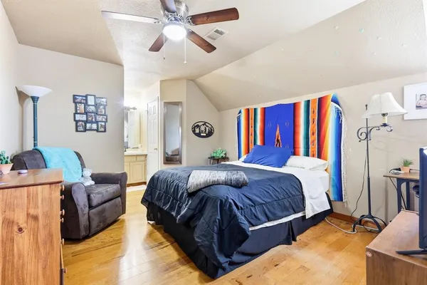 a bedroom with a bed couch and a window