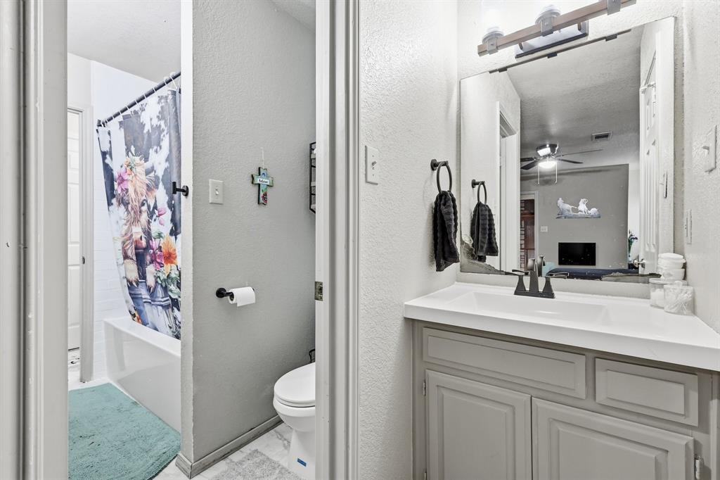 309 Sanders Road Denton, TX 76210 - Photo 19 of 40 a bathroom with a granite countertop sink toilet and shower