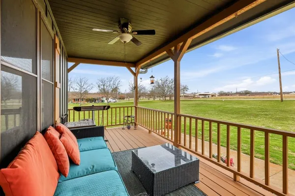 a balcony with furniture and a garden