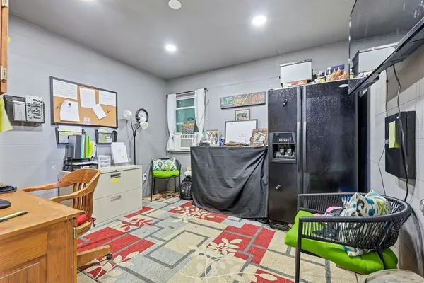 a living room with furniture a flat screen tv and a table