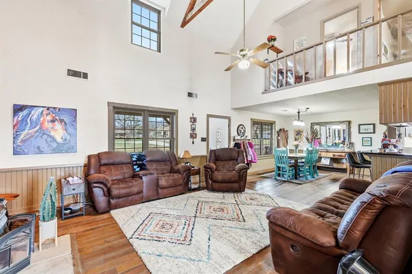 a living room with furniture or couch and a large window